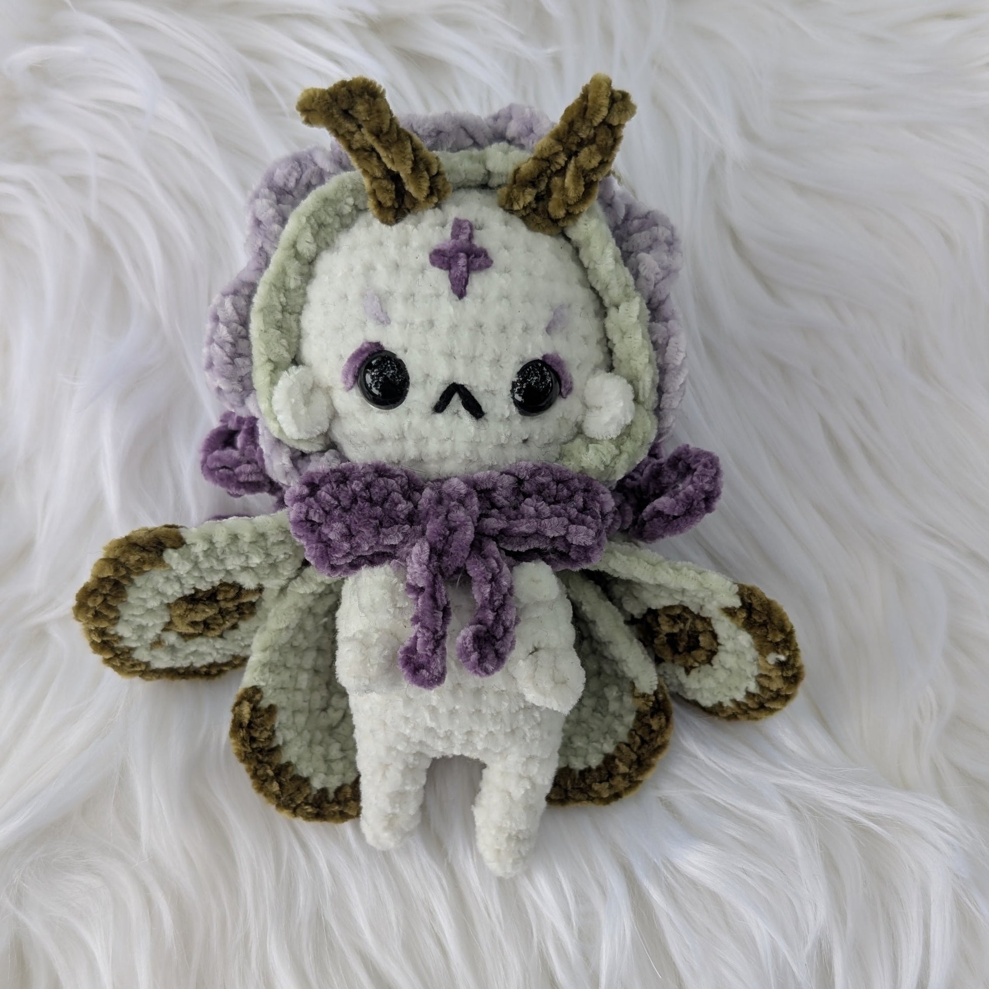 Handmade crochet moth-fairy plush in plum, sage, and cream chenille